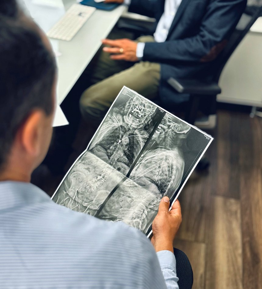 Un praticien examine une radiographie de la colonne vertébrale